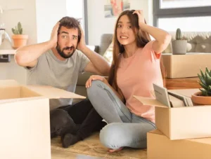 a man and a woman surrounded by cardboard boxes