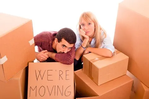 a man and a woman surrounded by cardboard boxes