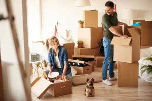 happy couple among removsl boxes